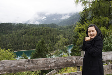 Fototapeta na wymiar Asia thai women travel and posing with view landscape of forest and Blindsee at Tyrol, Austria