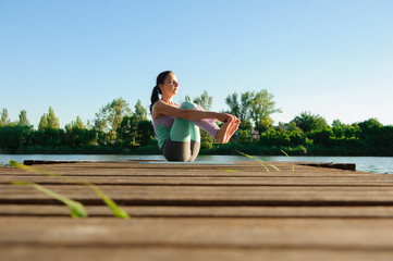 Young girl doing yoga fitness exercise outdoor in beautiful landscape. Morning sunrise. Meditation and Relax.