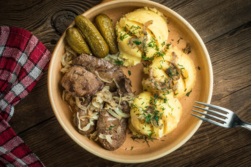 Fried chicken liver with onion served with mashed potatoes and pickled cucumber.