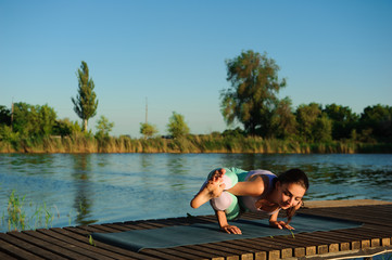 Healthy woman lifestyle balanced practicing meditate and energy yoga on the bridge in morning the nature. Healthy Concept.