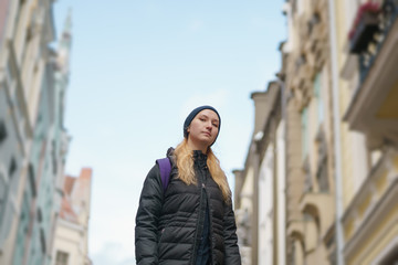 Fototapeta na wymiar portrait of teen girl walking in old europe city in autumn