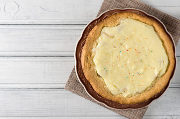 homemade whipped banana cream and cottage cheese cake on a wooden table with copy space