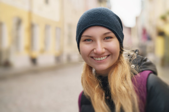 portrait of happy teen girl on street of old europe city