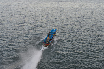 Long tail boat sailing in the river at sangkhla buri Thailand