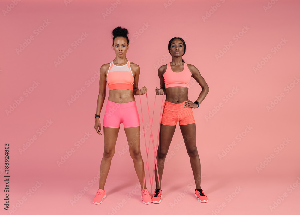 Sticker Two women doing exercises with resistance band