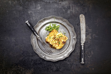 English shepherds pie as top-view on a pewter plate with copy space