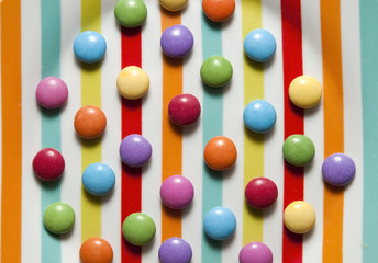 colorful candies on colorful stripes like a jolly background with sweet candy 