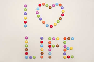 colorful candies creating the text  I love life  with shape of heart like a funny jolly concept of happy lifestyle 