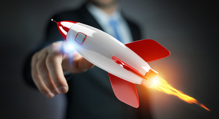 Businessman holding and touching a rocket 3D rendering
