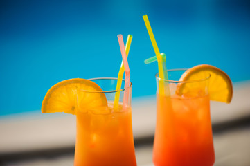 Cocktail next to swimming pool, summer vacation concept