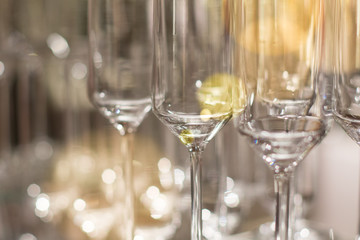 Elegant luxury shiny wine glasses lined up in rows on bar table background image