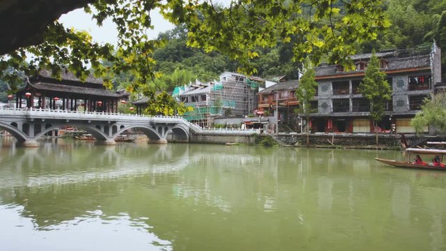 Wooden tourist boat sailing along the Tuojiang River
