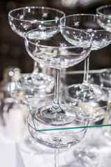 Array of cocktail glasses on a table prepared for dinner service.