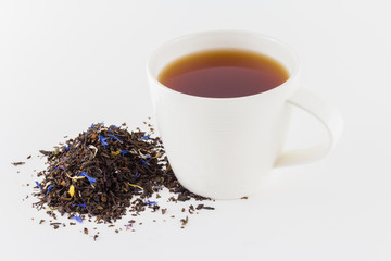 Tea cup with tea leaves isolated on white background