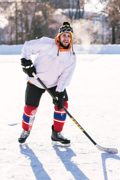 the man plays hockey on the rink