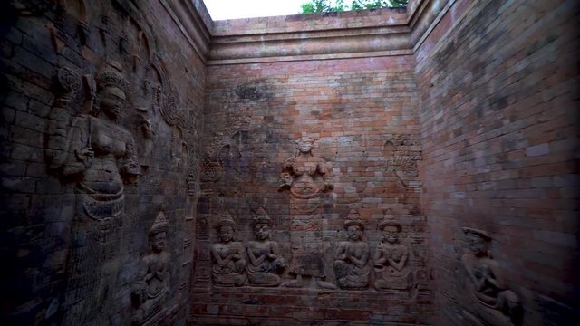 Steadicam gimbal pushing in and entering Prasat Kravan&rsquo;s northernmost tower featuring a pair of bas-reliefs of Lakshmi, Vishnu's consort, flanked by devotees