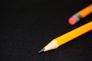 Two yellow Pencils on dark black blurred background. stationery. Office tool. Business concept....