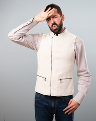 Handsome man with vest with fever on grey background