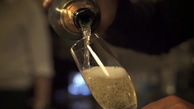 Filling a glass of champagne in slow motion.