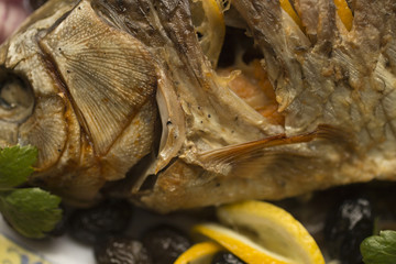 Stuffed carp, decorated with vegetables. Fish dish.