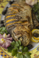 Stuffed carp, decorated with vegetables. Fish dish.
