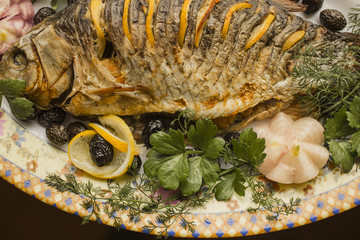 Stuffed carp, decorated with vegetables. Fish dish.