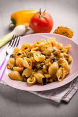 pasta with peas tomatoes capsicum and curry, selective focus