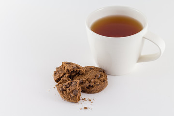 Cup of tea with chocolate cookies isolated on white background