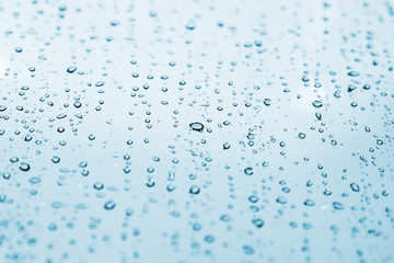 Water drops are on light blue glass