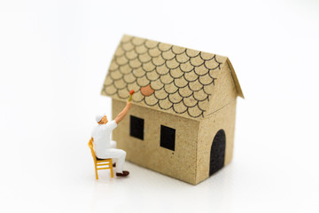 Miniature people: Workers are painting color the roof. Image use for Construction business concept.
