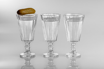 Three glasses of vodka with snack
