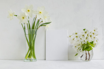 Mockup with a white frame and white daffodils in a vase