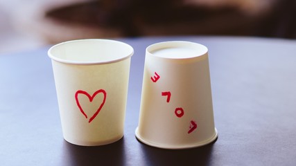 Love phase and heart drawing on paper cup.