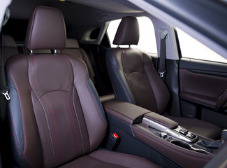 Luxury car inside. Interior of prestige modern car. Comfortable leather seats. Red perforarated leather cockpit. Isolated windows, clipping path