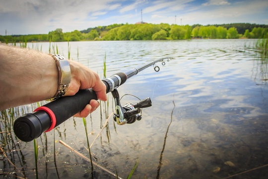 Premium Photo  Spinning with reel and sunny summer lake, fishing rod