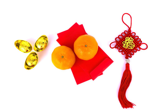 Chinese New Year Background - Red Envelope, Mandarin Orange, ornaments and Gold Ingots with Chinese Character Happiness and Prosperity on white background.