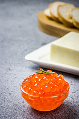 Red caviar butter and sliced bread , ready for making sanwiches. Selective focus, space for text.