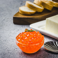 Red caviar butter and sliced bread , ready for making sanwiches. Selective focus, space for text.