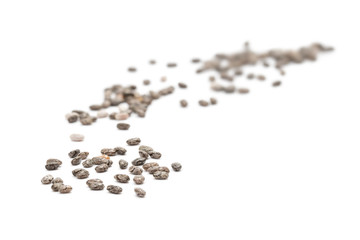 Close up of some linseed isolated on white with focus in the front and blurred background