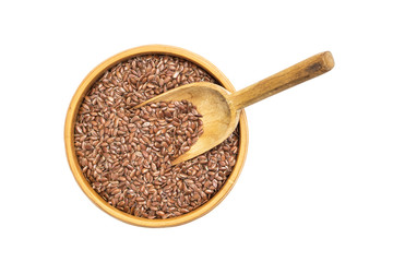 Linseed or flax seed in a wooden bowl and a spoon in it seen from above isolated on white background
