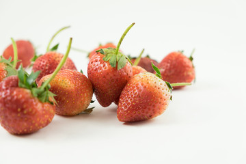 Close up of the strawberries on the white background.