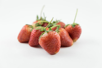 Close up of the strawberries on the white background.