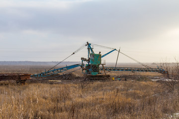 a lone excavator in the steppe