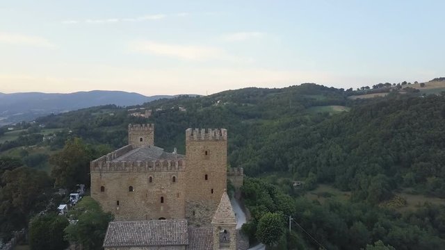 Zoom out of old italian castle nestled in vally