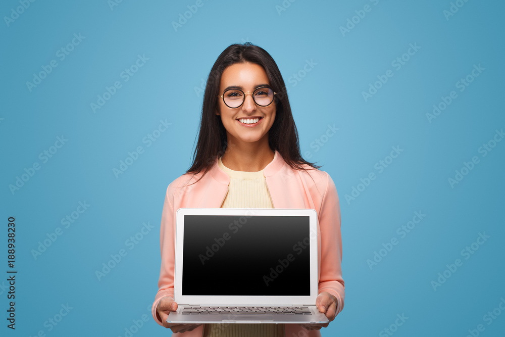 Wall mural Happy business woman holding laptop