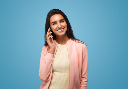 Latin american young business woman holding smartphone
