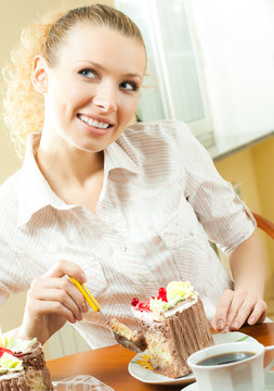 Cheerful blond young woman eating torte