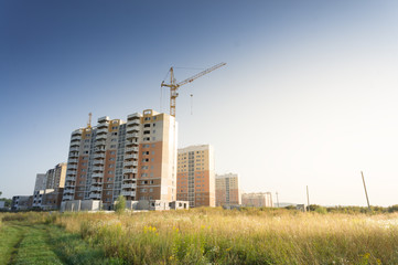 Fototapeta na wymiar Modern high rise buildings and new structures with cranes in the