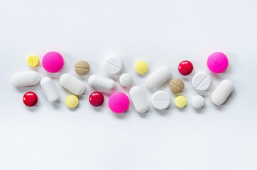 Top view of the pills on the white background, The drug and capsule pills on the floor, Pile of the drug and pills on the white background.