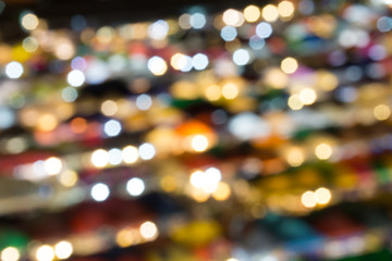 defocused of multi color light and plastic roof of ratchada train night market,bangkok. for christmas and new year abstract background concept.